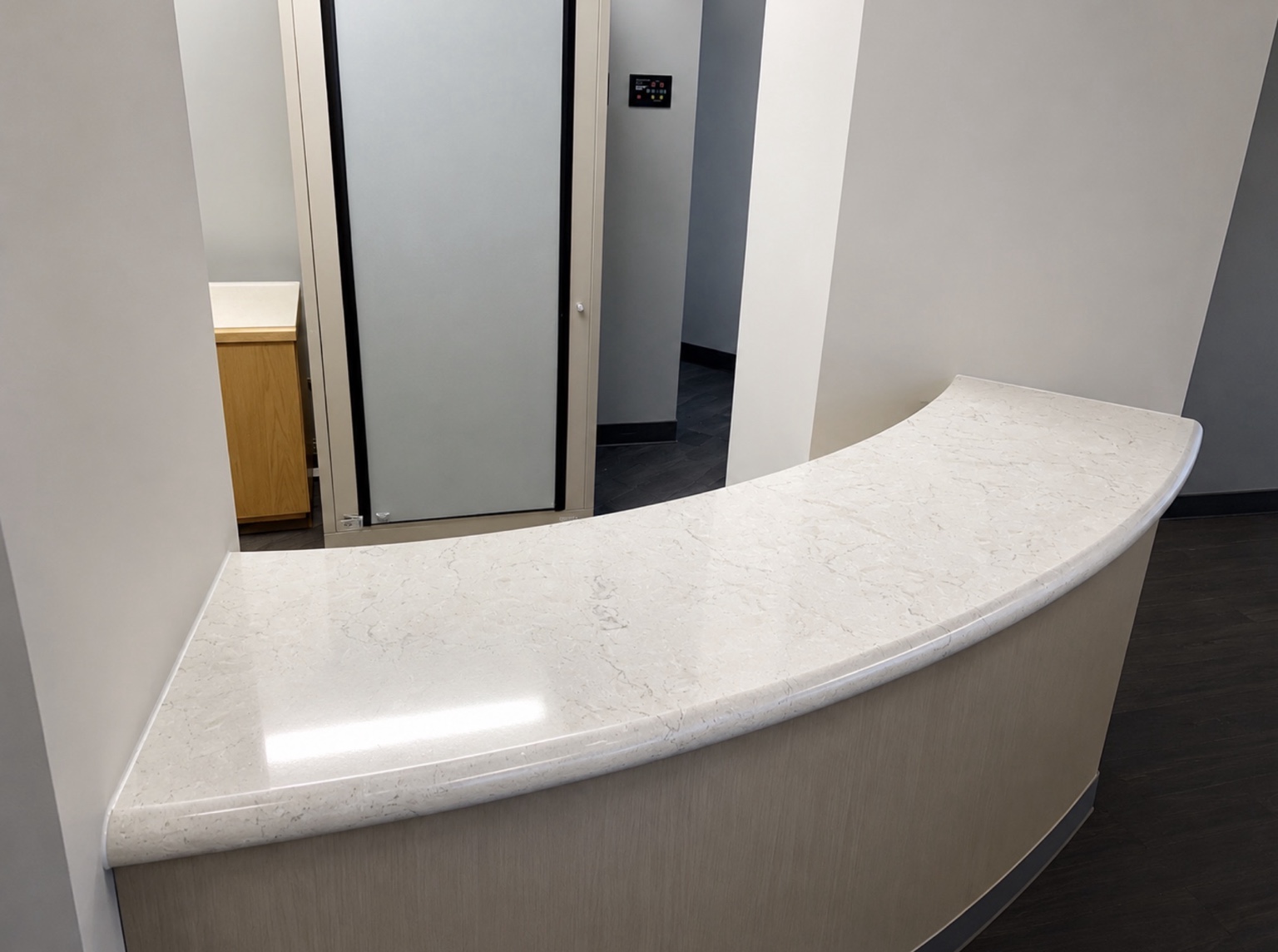 Front of the curved quartz reception counter with a 4 cm bullnose edge