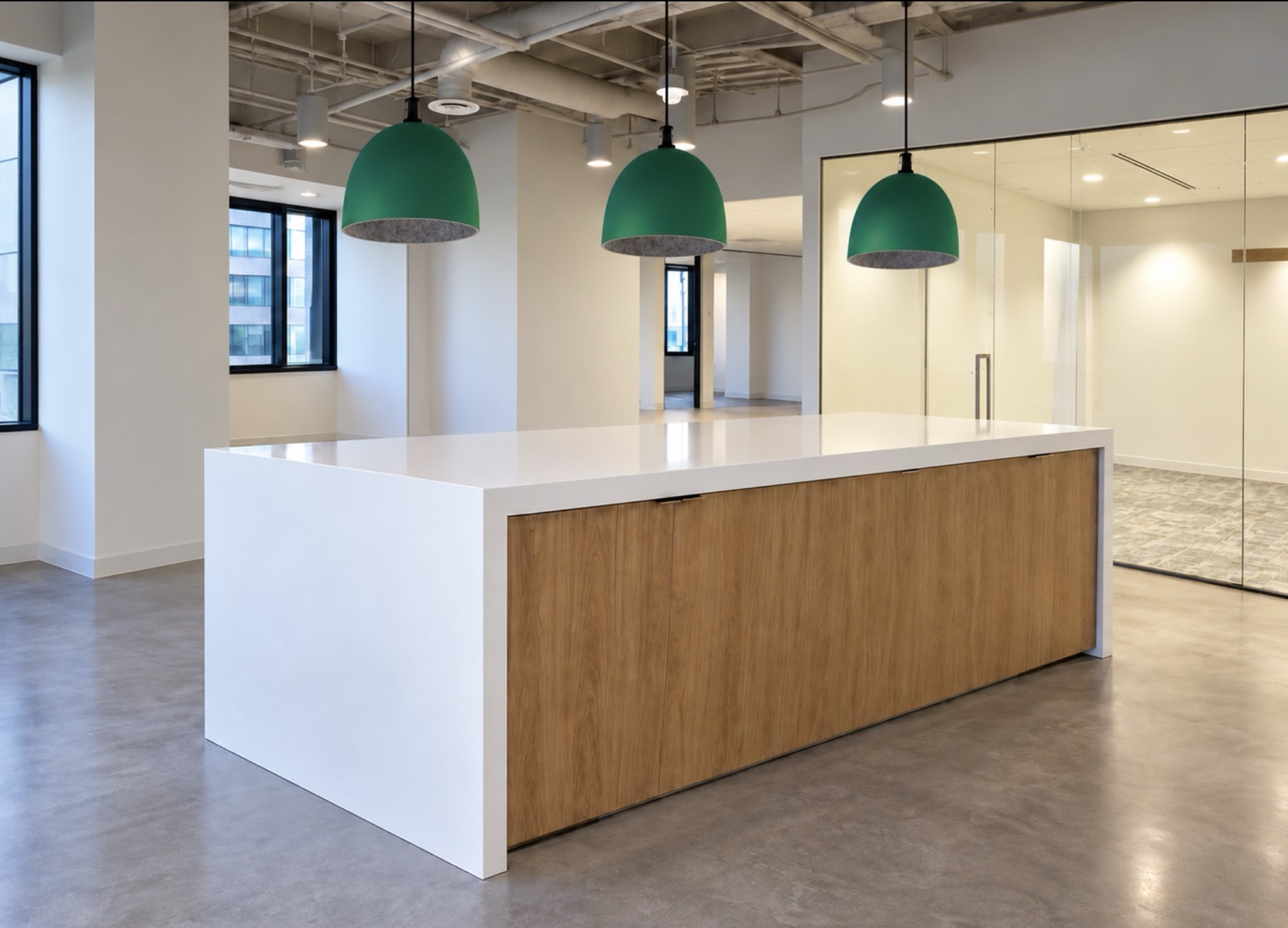 Commercial quartz island with waterfall panels and double-wrapped mitered edges framing wood cabinetry beneath green pendant lights